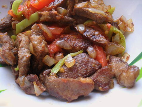 Pork pieces with vegetables in a pan