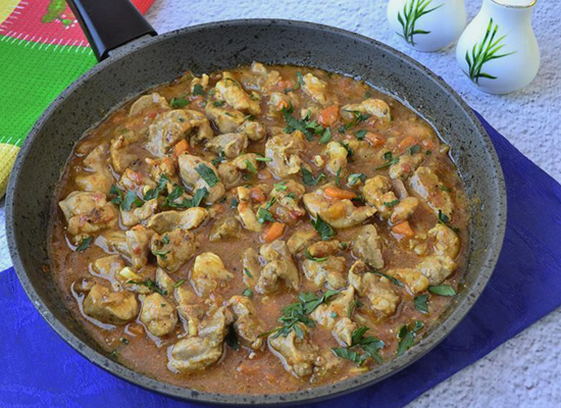 Pork meat stewed in pieces in a pan