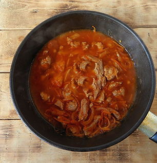 Pieces of pork with gravy in a pan