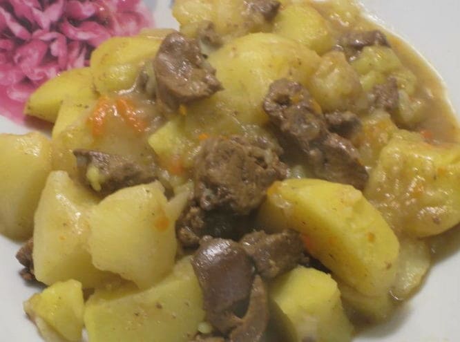 Braised potatoes with chicken liver in a saucepan