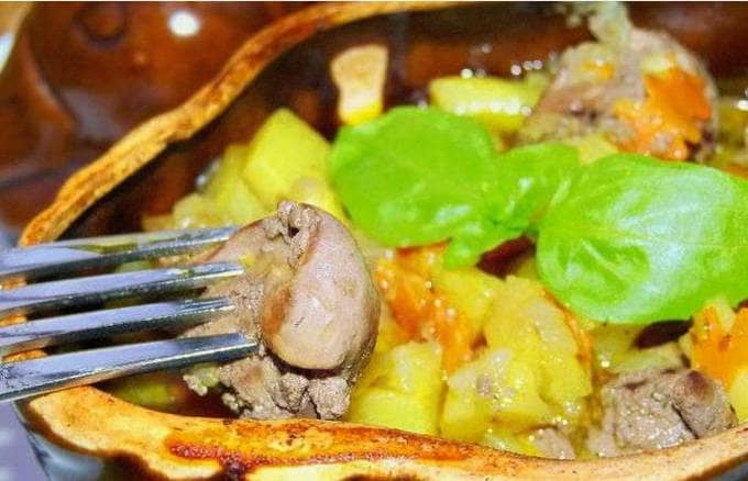 Chicken liver with potatoes in a pot in the oven