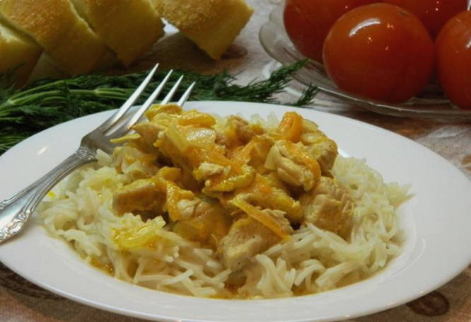 Pieces of turkey with sour cream in a pan