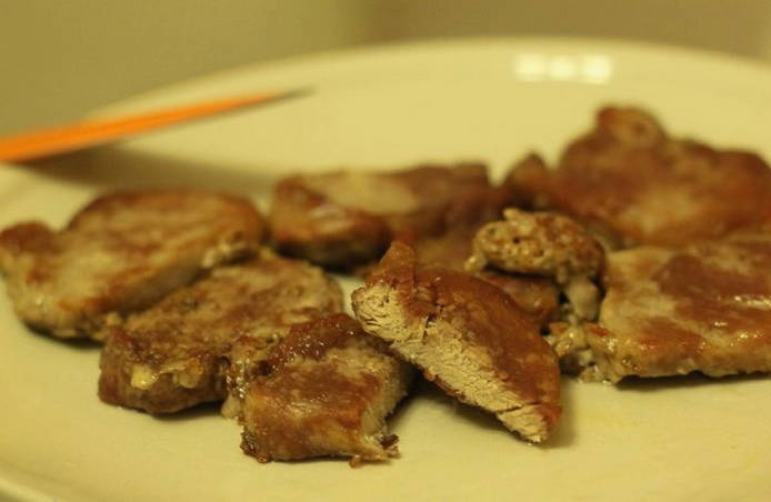 Pork tenderloin in pieces in a pan