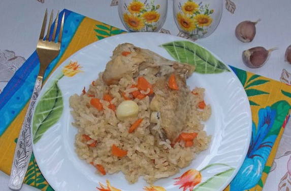 Pilaf with chicken in a duck on the stove