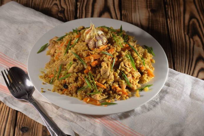 Bulgur pilaf with chicken in a cauldron