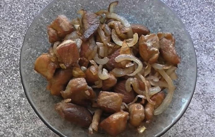 Pork shoulder in pieces in a pan