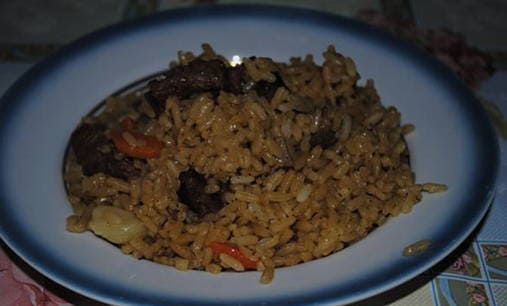 Beef pilaf in a roaster on the stove