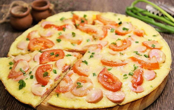 Pizza with mayonnaise and sour cream with egg in a pan