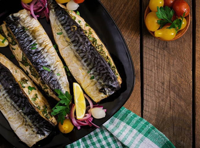 Mackerel with mustard in foil on the grill