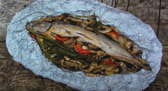 Mackerel with vegetables in foil on the grill