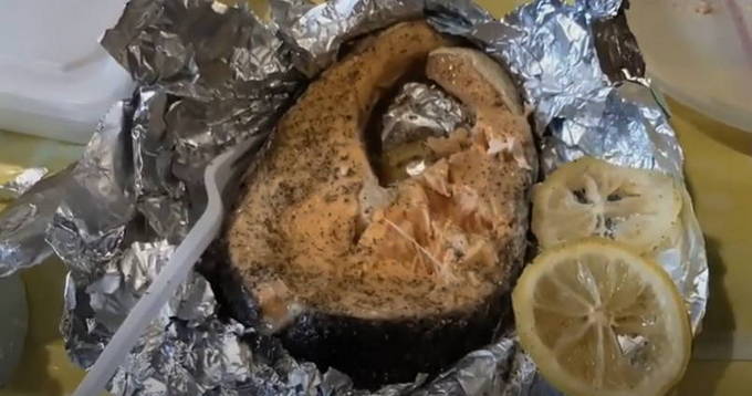 Red fish in foil on the grill
