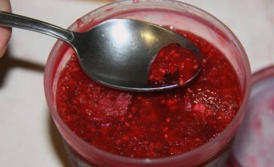 Raspberries mashed with sugar in the freezer for the winter