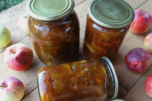 Transparent jam with apple slices and orange