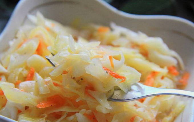 Hot pickled cabbage with carrots, vinegar and instant oil