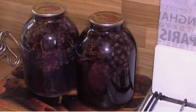 Grape compote with twigs on a 3-liter jar for the winter