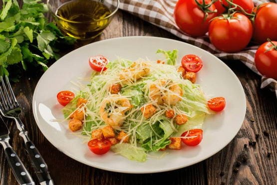 Caesar salad with shrimps and cherry tomatoes