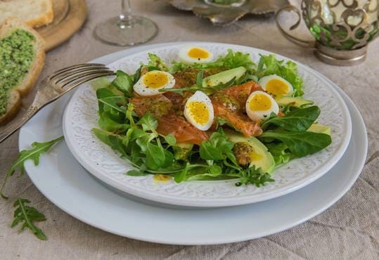 Salad with avocado, salmon and quail eggs